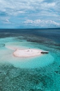 Small island with white sand and turquoise waters in East Gili, Indonesia.