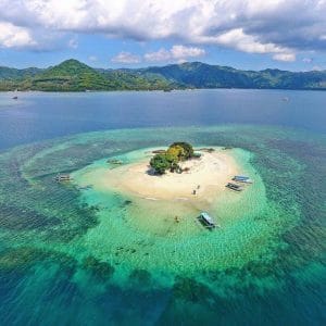 Scenic view of Gili Nanggu with turquoise waters and boats around the island.