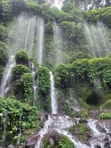 Scenic view of Benang Kelambu Waterfall with lush greenery and cascading water.