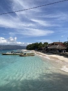 Beautiful Gili Islands beach with boats and clear turquoise water.
