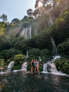 Tourists enjoying the scenic Benang Kelambu Waterfall in Lombok.