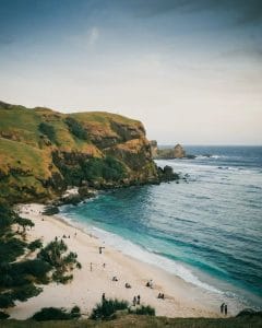 Beautiful beach in South Lombok with cliffs and clear blue water.