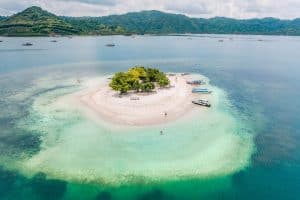 Beautiful island with white sandy beach and boats near Gili Islands.