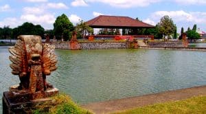 Scenic view of Mataram city park with water and traditional sculpture.