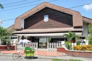Nusa Tenggara Barat Museum building in Mataram with tropical plants.